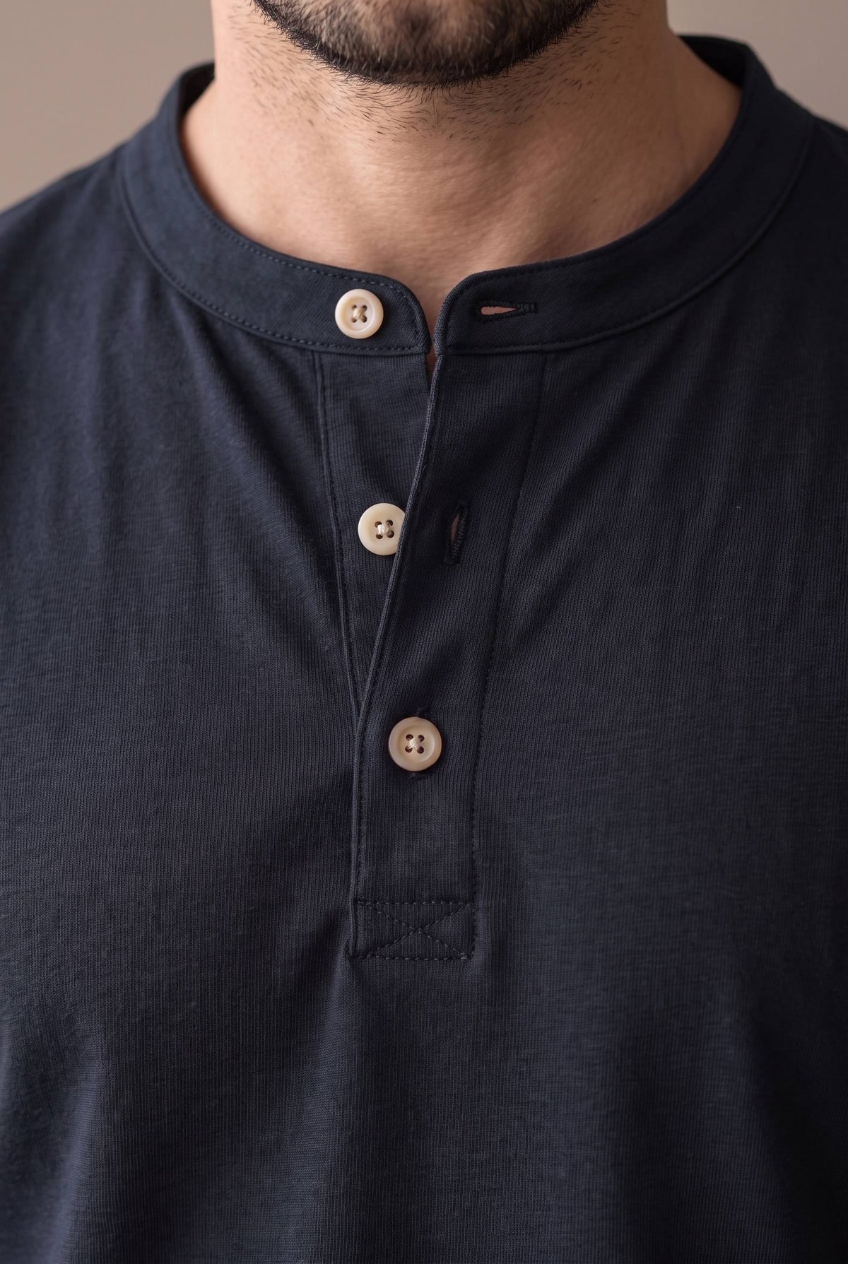 Detalle de los botones de corozo y la cartera de la camiseta henley negra.