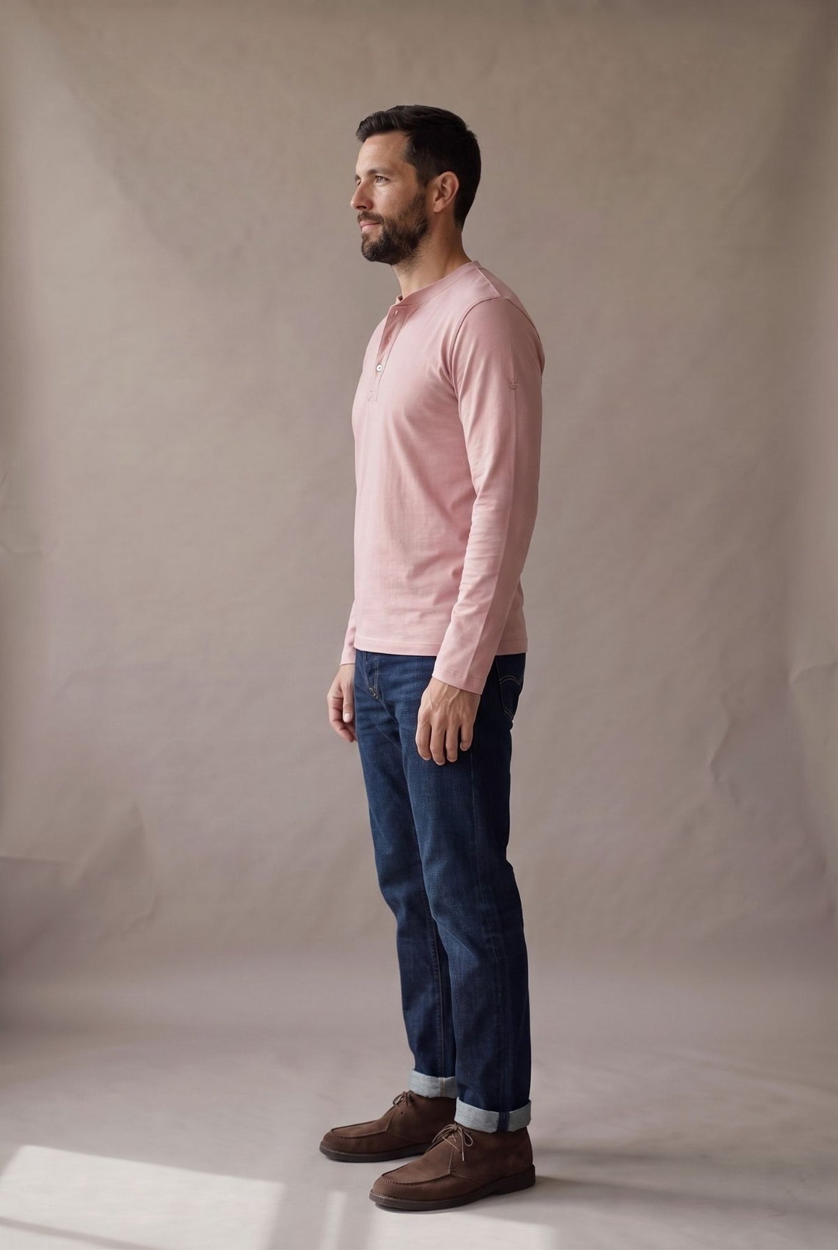 Vista lateral de la camiseta henley manga larga rosado palo de rosa con puño liso y caída limpia.